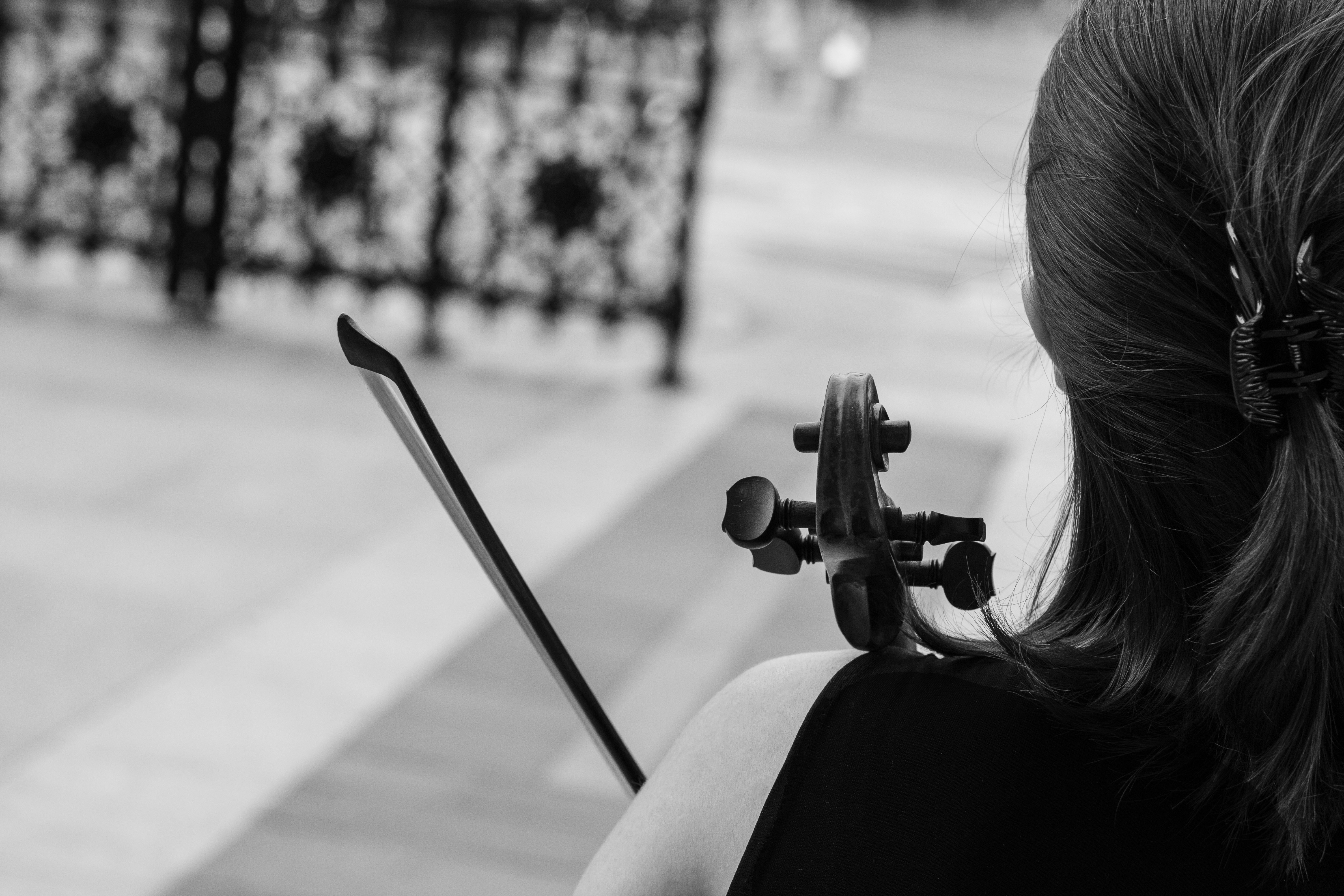 Violinist seen from behind in a black-and-white photograph